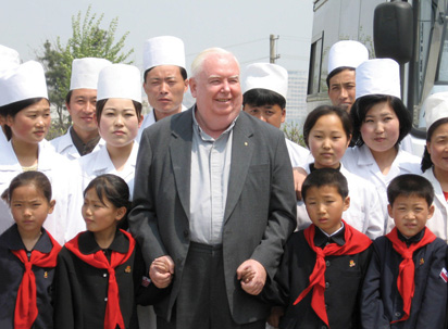 Father Gerard Hammond, M.M., enjoys time with children and workers at Anju City Tuberculosis Center, North Korea.