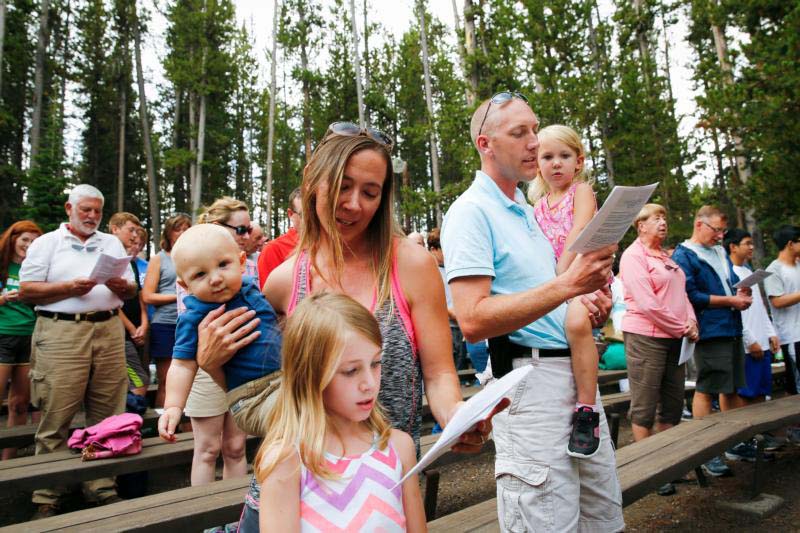 The Heinlein family of Ionia, Mich., attends Mass in the Canyon section of Yellowstone National Park in Wyoming. Summertime is busy and full of the unexpected, but it's precisely in this chaos that we must find Christ. He is in the middle of our tornado of life, the one spinning with barbecues and camping trips and late summer nights. (CNS photo/Nancy Wiechec) 