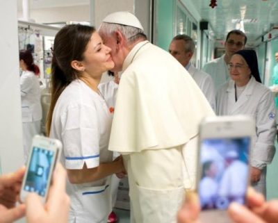 Pope Francis greets a nurse during a visit to the Bambino Gesu children's hospital in Rome in this 2013 file photo. Two former top hospital officials appeared before a Vatican court July 18 for a pretrial hearing on allegations of embezzlement. (CNS photo/L'Osservatore Romano via Reuters) 