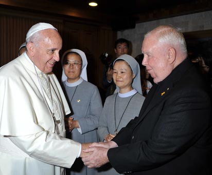 Pope Francis meets Maryknoll Father Gerard Hammond, a native of Philadelphia who has lived in South Korea since 1960, before a meeting with the bishops of Korea in Seoul Aug. 14. Father Hammond said he has made 51 trips since 1995 into North Korea to bring humanitarian assistance. (CNS photo/L'Osservatore Romano) 