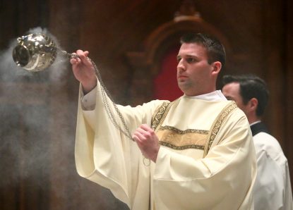 Rev. Mr. Kyle Adamczyk blesses the congregation with incense during the Chrism Mass March 29 at the Cathedral Basilica of SS. Peter and Paul.