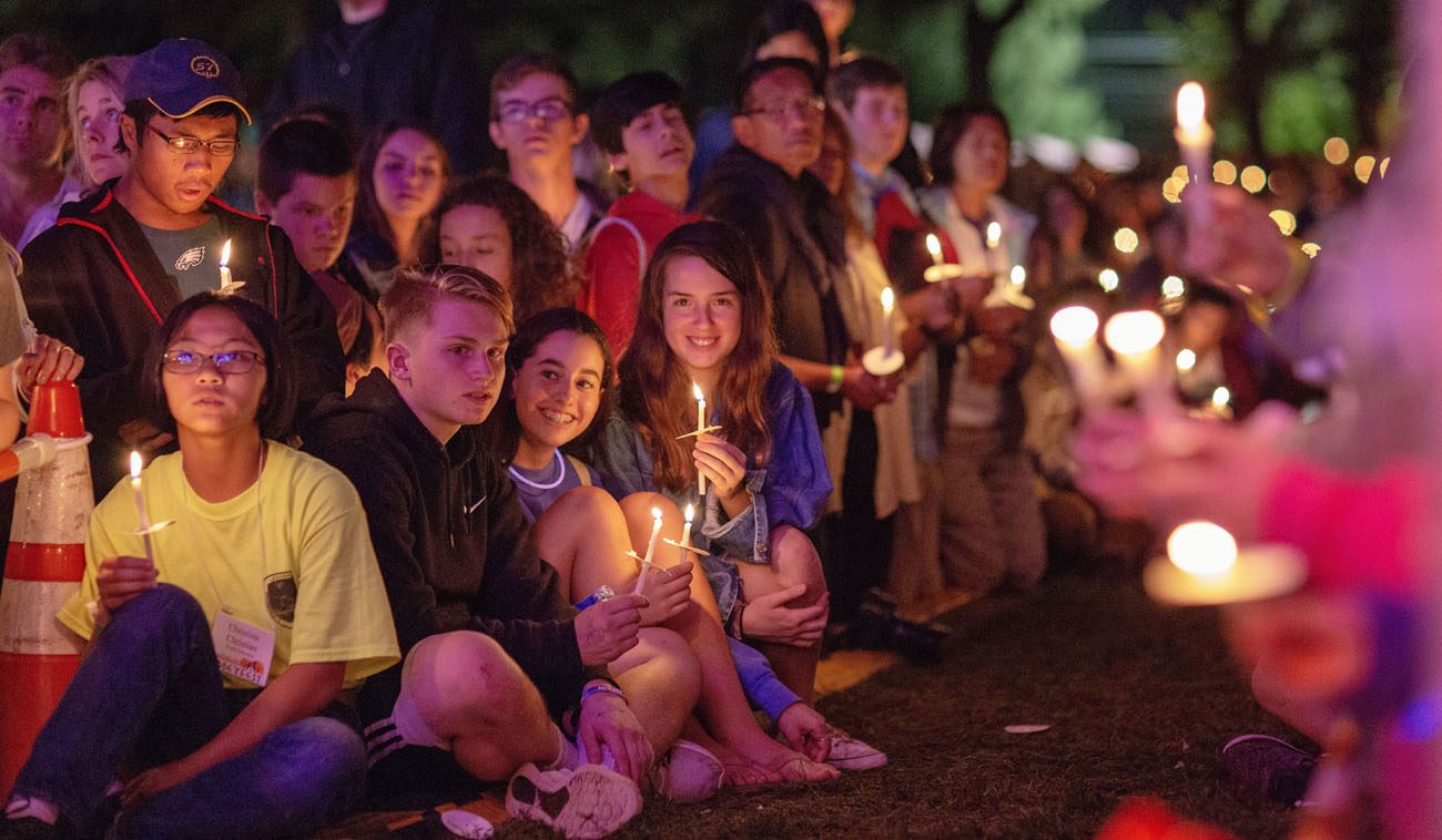 Teens enjoy prayers by candlelight at AbbeyFest on the grounds of Daylesford Abbey, Paoli. (Photo by Michelle Kilgore)