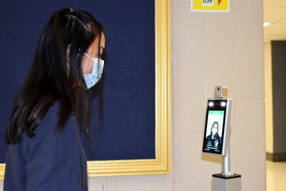 Presidential Ambassador and senior Grace Drewicz has her temperature checked as soon as she enters Pope John Paul II High School for the start of the day. (Photo by Shannon Villa)