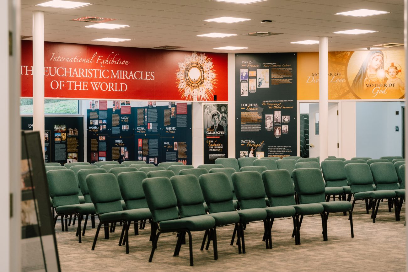 Visitors explore the International Exhibition of the Eucharistic Miracles of the World during a Carlo Acutis canonization pilgrimage at the official shrine in Malvern Retreat House, Archdiocese of Philadelphia.