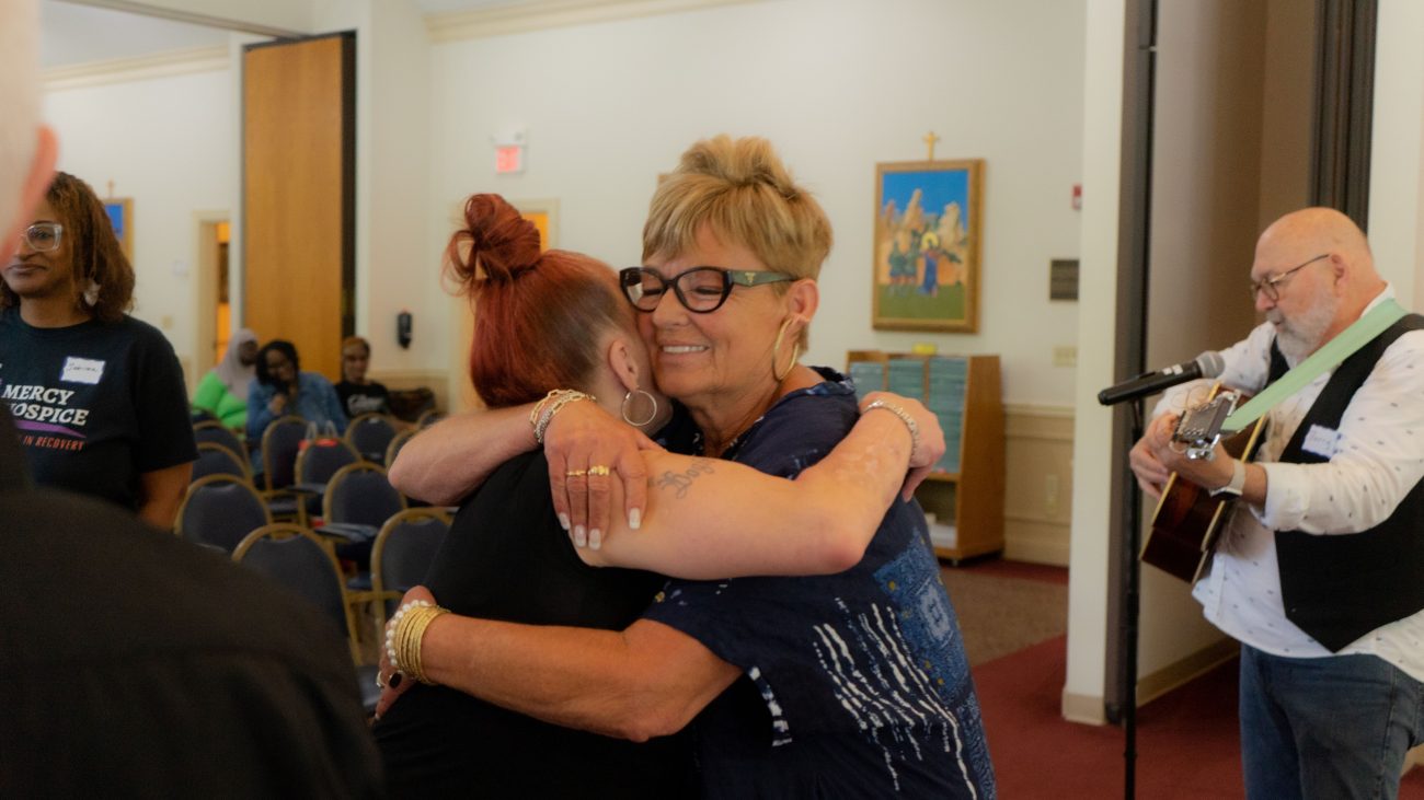 Amy Stoner hugs a woman attending the Dorothy Day Retreat, hosted by Catholic Charities of Philadelphia to offer spiritual renewal and support to women impacted by homelessness.